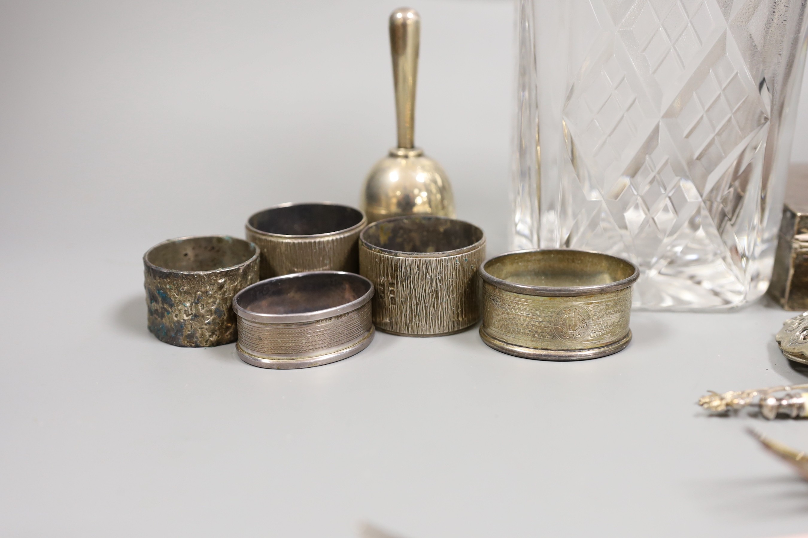 Mixed silver items etc. including a modern silver collared glass decanter, cigarette box, 800 standard white metal cake tongs, a white metal hand bell(lacking clapper), six plated Noritake tea forks, assorted minor silve